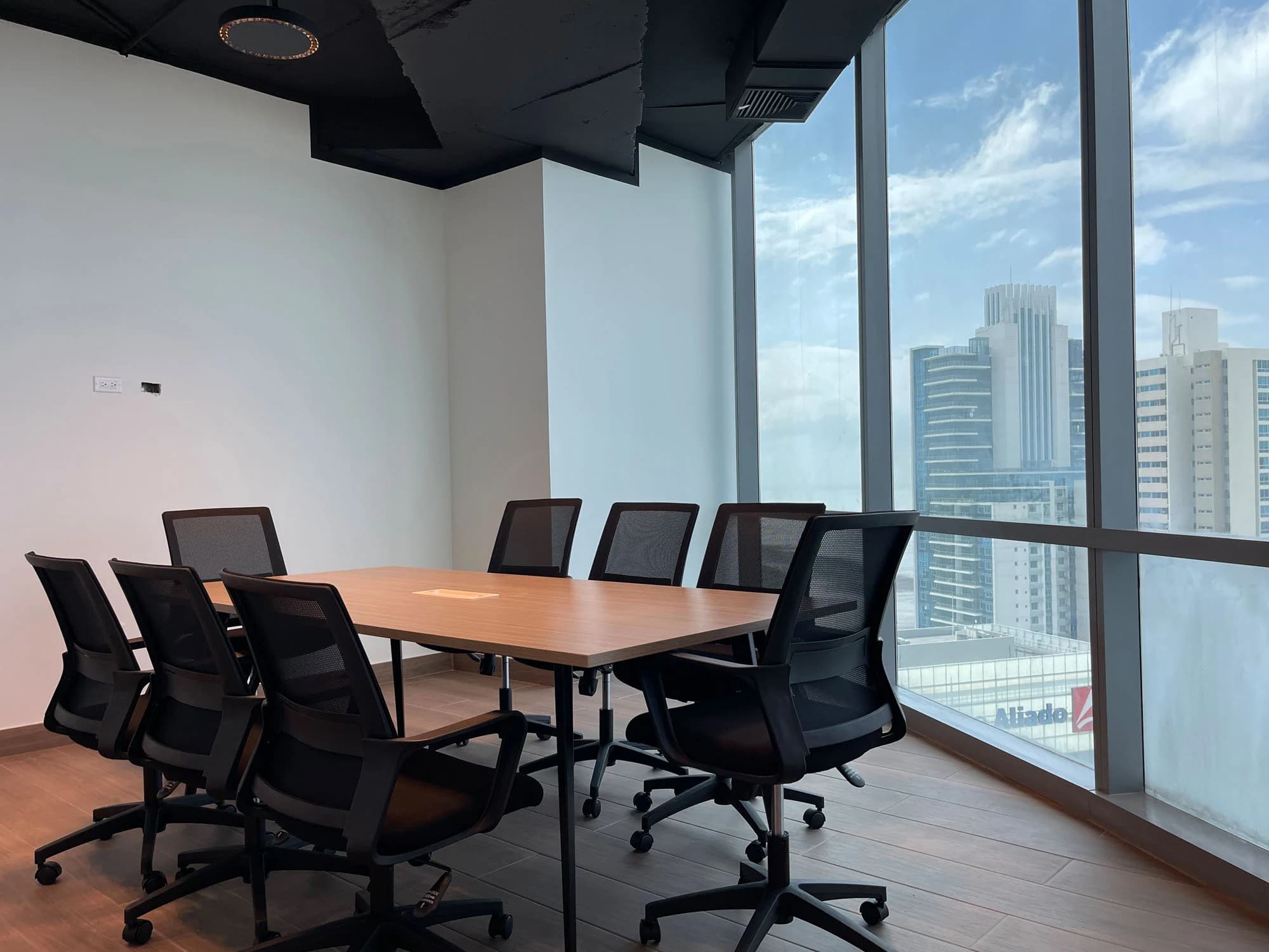 A meeting space with city-facing windows.